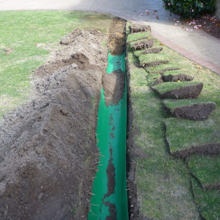 Root barrier laid in trench